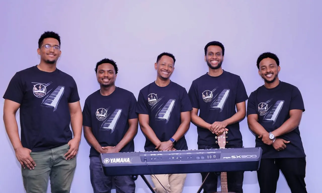 The Misgana team standing together with a keyboard and guitar